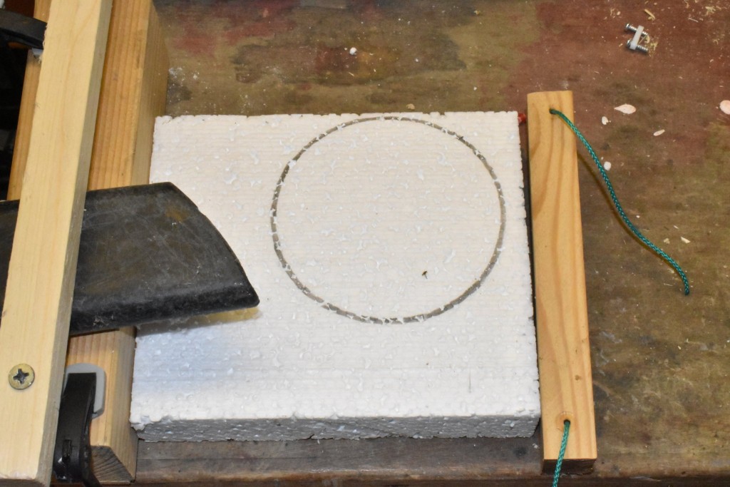 Die Nistmulde wird so eingezeichnet, dass sie später möglichst weit vom Einflug entfernt liegt. Links im Bild die Ansaugdüse eines Staubsaugers, die später die anfallenden Styropor.Flocken aufsaugen wird